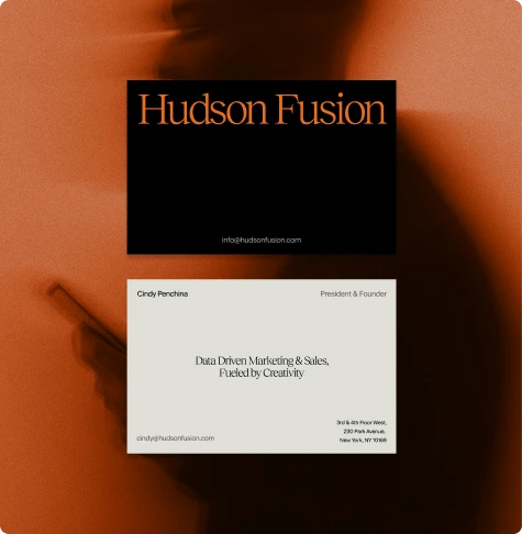 Hudson Fusion business card designs in black and cream against an orange photographic background