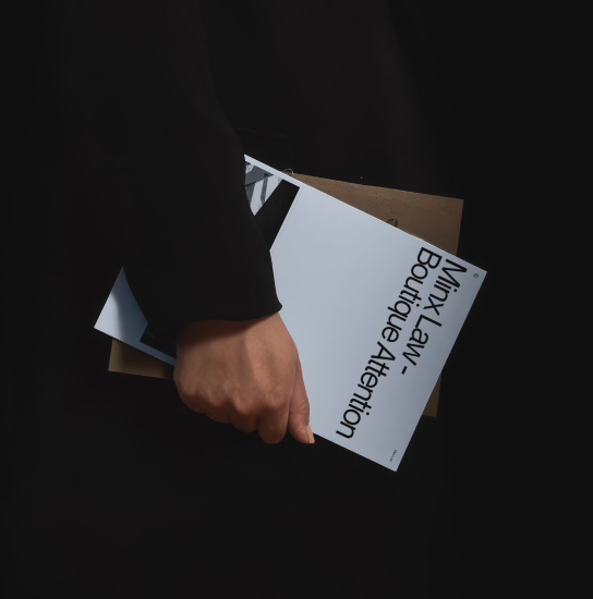 Minx Law stationery held against a black background
